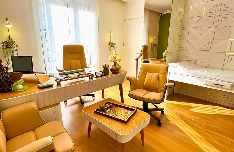 Consultation room with the desk, armchairs and an examination couch
