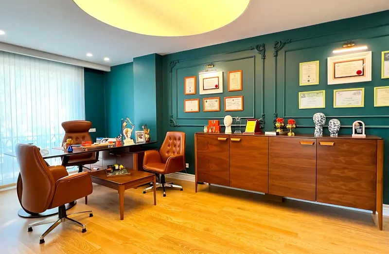 Dr. Yilmaz's office with a leather desk chair and framed diplomas